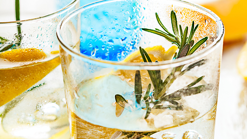 Glass of cocktail garnished with Rosemary spring