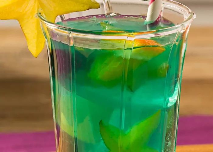 Glass of Blue Lagoon Sangria garnished with starfruit slice 