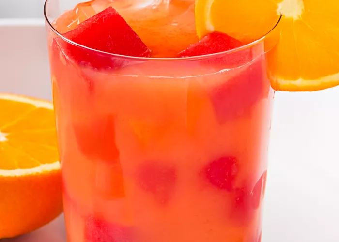 Glass of Juicy Screw garnished with orange slice 