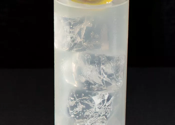 Glass of EFFEN® Raspberry Lemonade garnished with lemon slice and raspberry on glass coaster