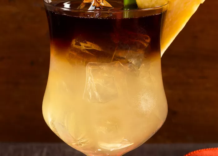 Glass of Cruzan® Mai Tai garnished with pineapple wedge and leaf 