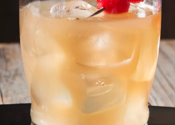 Glass of Tropical Spice garnished with cherries