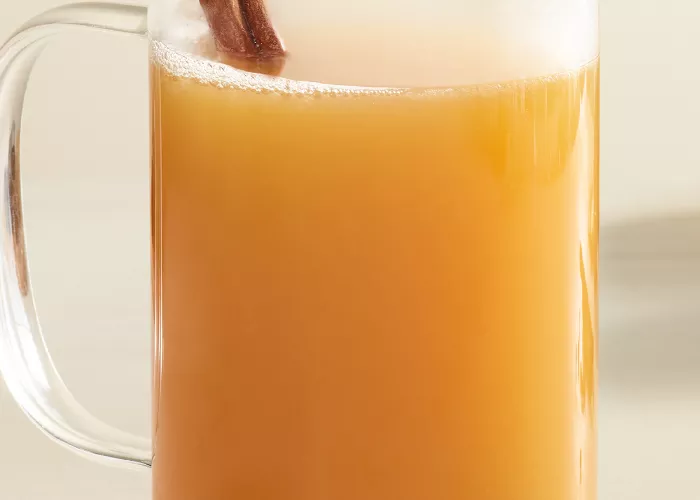 Mug of Cruzan® Spiced Apple Cider garnished with cinnamon stick