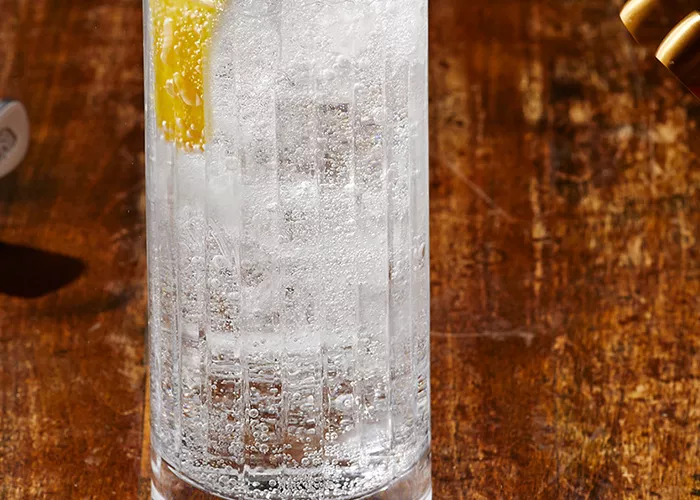 A glass of Haku® Highball (“Haku-Hi”) garnished with lemon peel