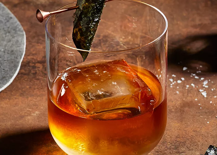 A glass of Legent® Sea 'New' Fashioned garnished with Nori Strip 