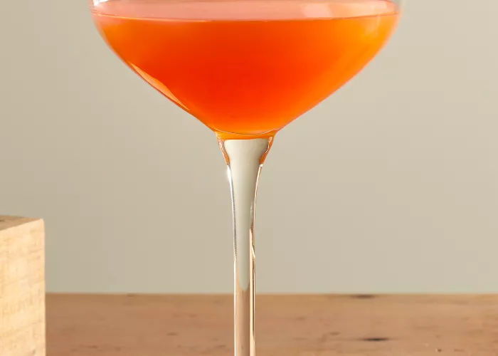 A glass of  Maker's Mark® Paper Plane garnished with Lemon Peel