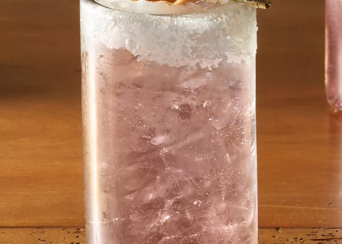 A glass of Tres Gen® Paloma garnished with Grapefruit Peel 