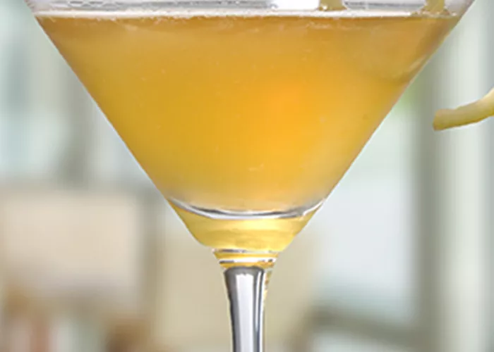 Glass of Shining Light Spice garnished with lemon peel