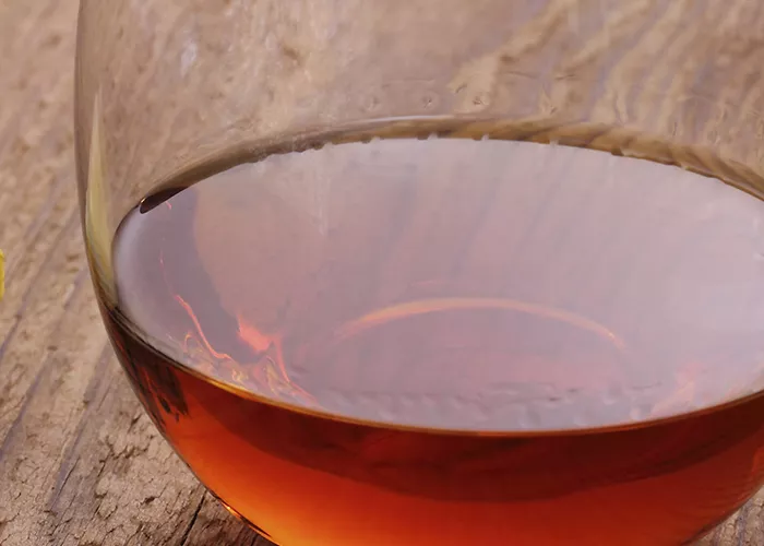 A glass of crusta with a drink and ice