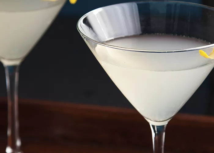 Two glass of Elderflower Martini garnished with lemon peel