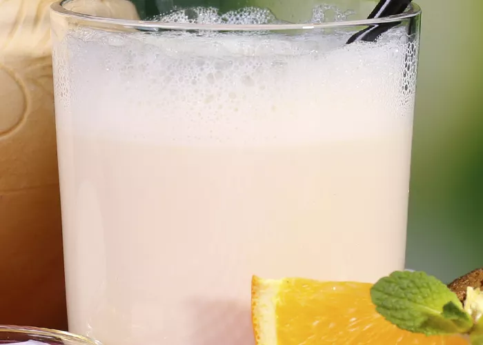  A glass of jimmy chocolate on a wooden table.