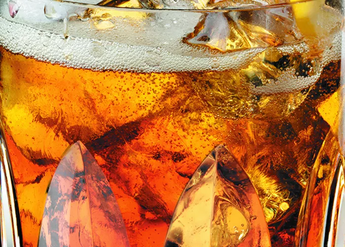 Glass of Maker's Mark® Presbyterian with  crushed ice and garnished with a lemon twist. 