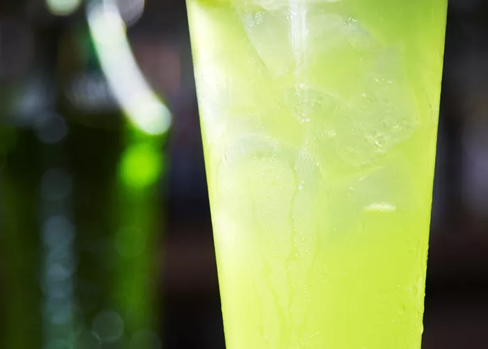 Glass of Apple Fizz garnished with lemon wedge