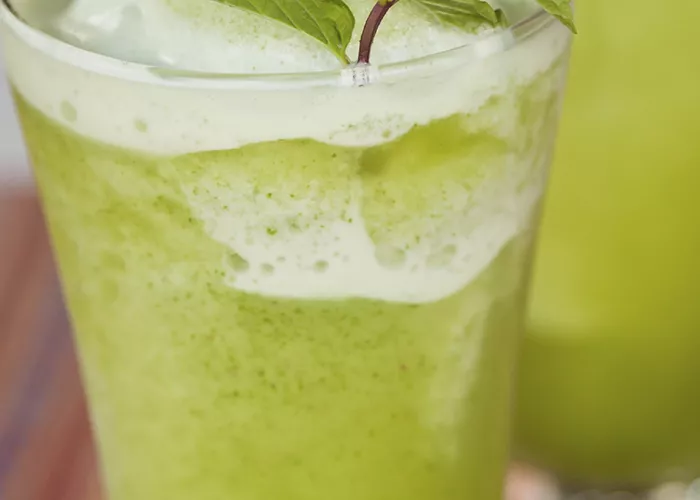 Glass of Melon Splash garnished with mint leaves.