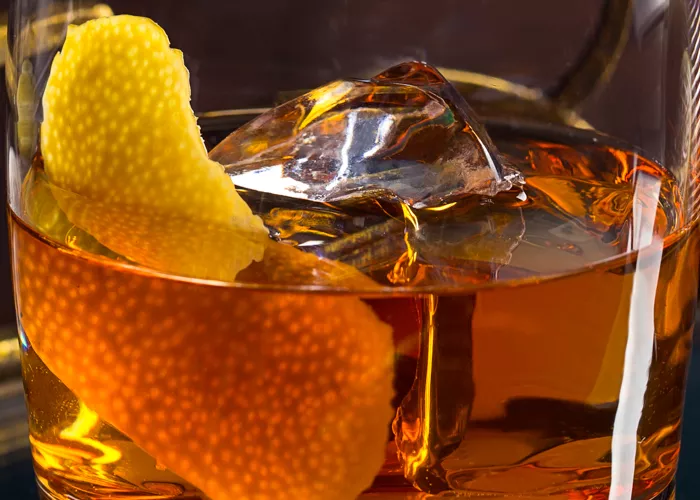 Glass of Dry Rye Manhattan garnished with lemon peel