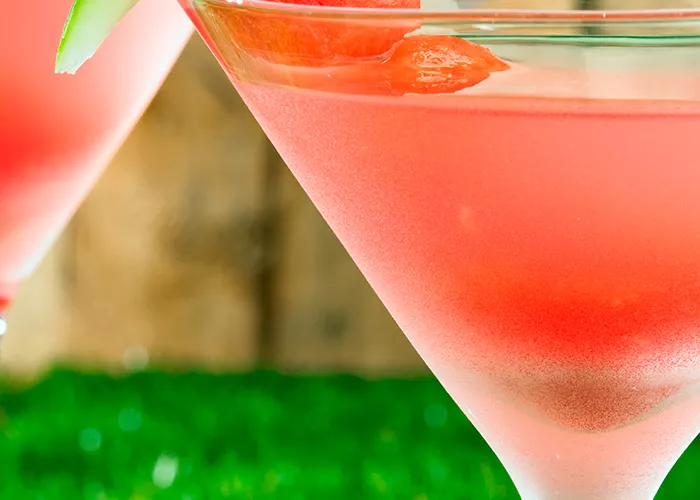 Two glasses of Watermelon Martini garnished with a slice of watermelon.