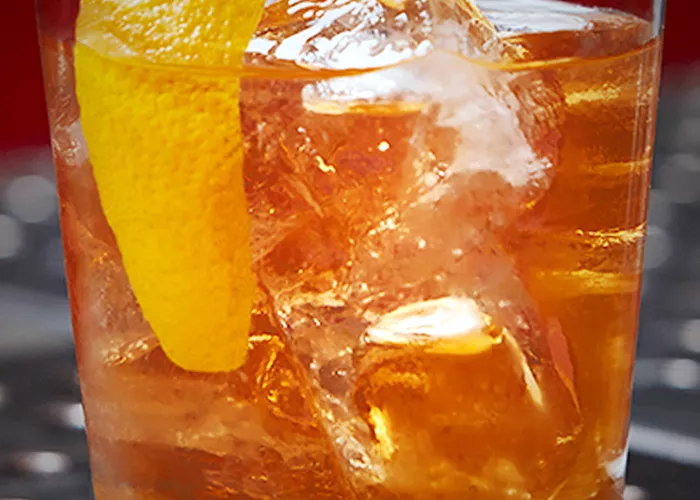 a glass of contemporay with a lemon wedge
