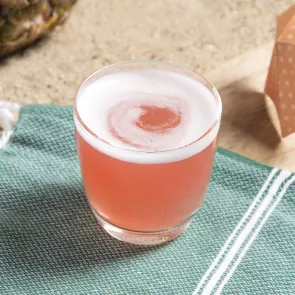 Glass of Sex On The Beach on green piece of cloth