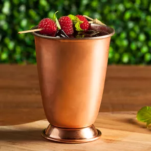 Glass of Berry Moscow Mule with raspberries and mint leaves