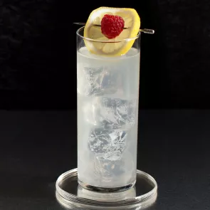 Glass of EFFEN® Raspberry Lemonade garnished with lemon slice and raspberry on glass coaster