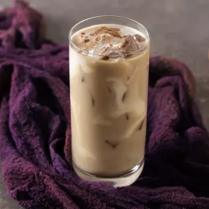 Glass of Pumpkin Spice White Russian on purple cloth
