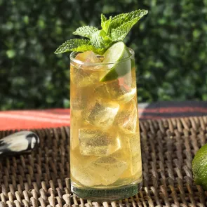 Glass of Derby Spritzer garnished with mint leaves and lime wedge