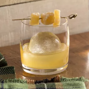 Glass of Laphroaig® Penicillin garnished with candied ginger