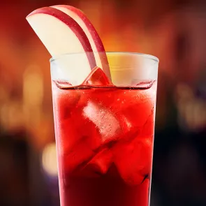 Glass of Red Zone garnished with apple slices