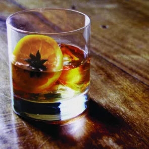 Glass of Knob Creek® Single Barrel Reserve Old Fashioned garnished with lemon slice and Star anise