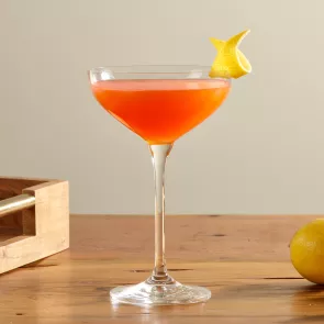 A glass of Maker's Mark® Paper Plane garnished with Lemon Peel
