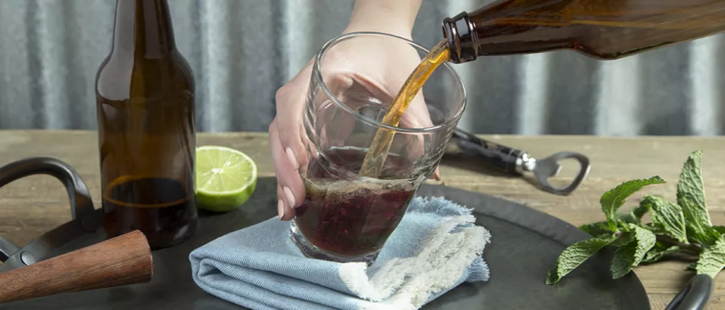 Peron pouring Berry Good Shandy into glass