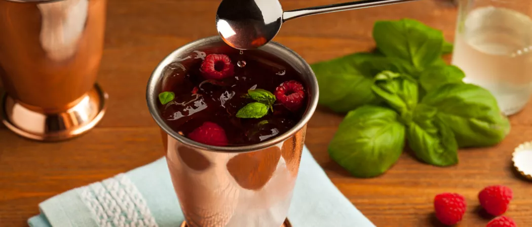 Glass of Berry Moscow Mule with raspberries and mint leaves
