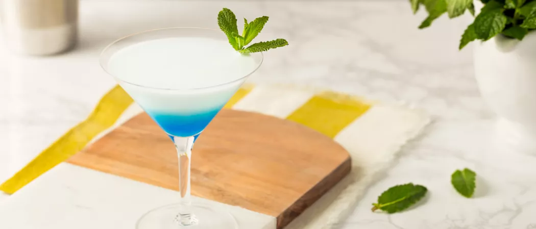 Glass of DeKuyper® Mintini garnished with mint leaves