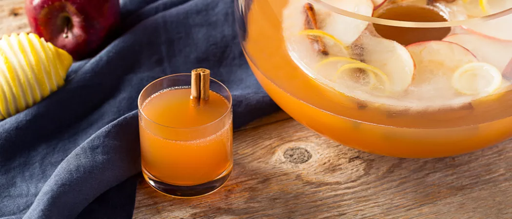 Glass of Spiced Christmas Punch garnished with cinnamon stick