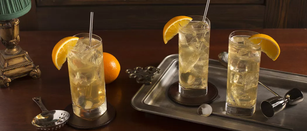 Three glasses of Derby Fizz garnished with orange wedge