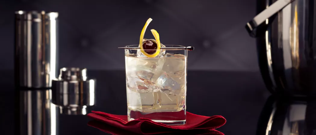 Glass of Vodka Beast Garnished with cherries.