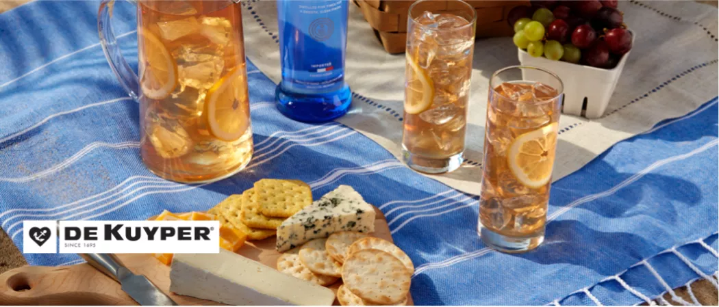A glass of LemonWedge garnished with LemonWedge along with some buiscits and cheeze and a bottle of pinnacle vodka