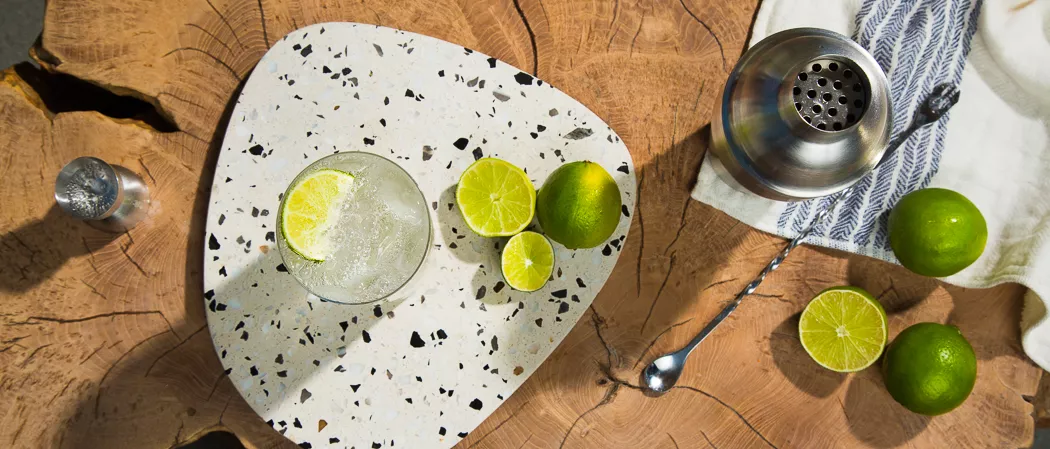 Two glasses of Hornitos® Ranch Water garnished with Lime Wedge along with chopped lemons