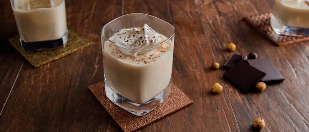 A glass with bourbon ball with some chocolate pices