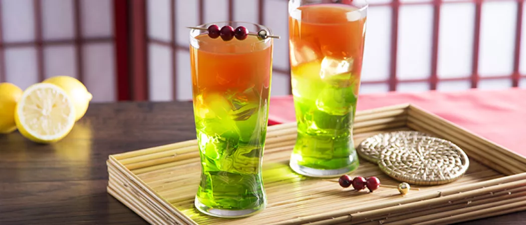 Two glass of Elf`s kiss on wodden tray with lemon pices