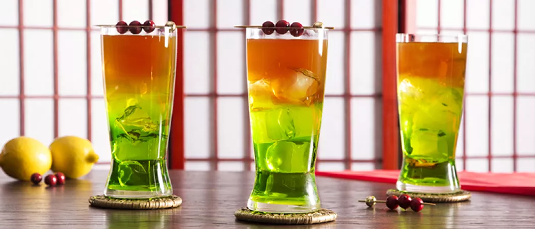 Three glass of cocktail on wodden table with tow lemon