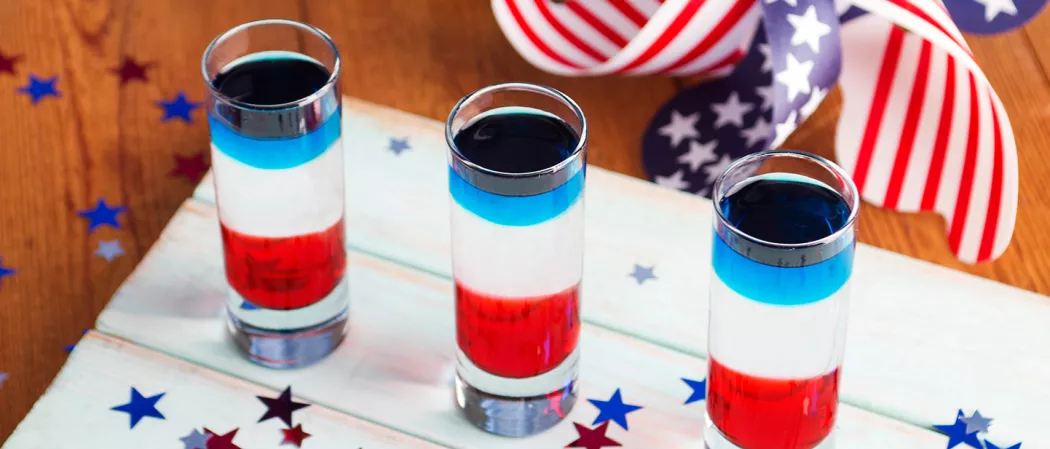  Three glasses of Red, White, and Blue Shot on a white table