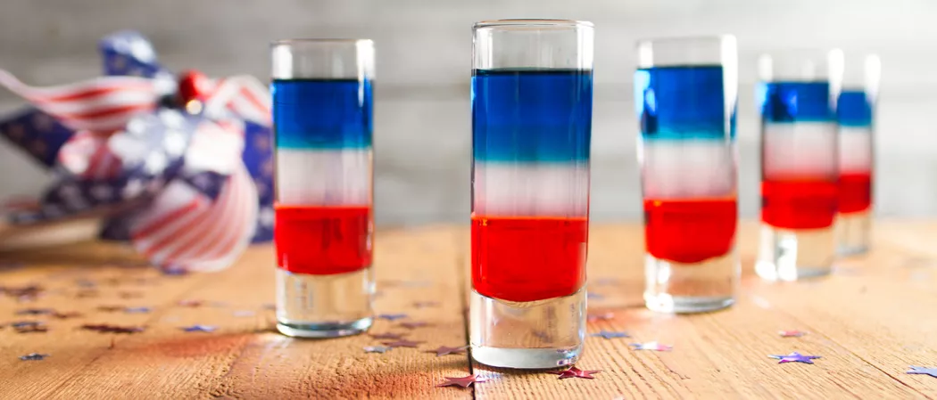 Five glasses of Red, White, and Blue Shot on a wooden table