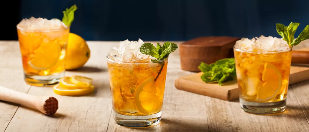 Three glasses of Whisky Smash garnished with crushed ice and mint leaves
