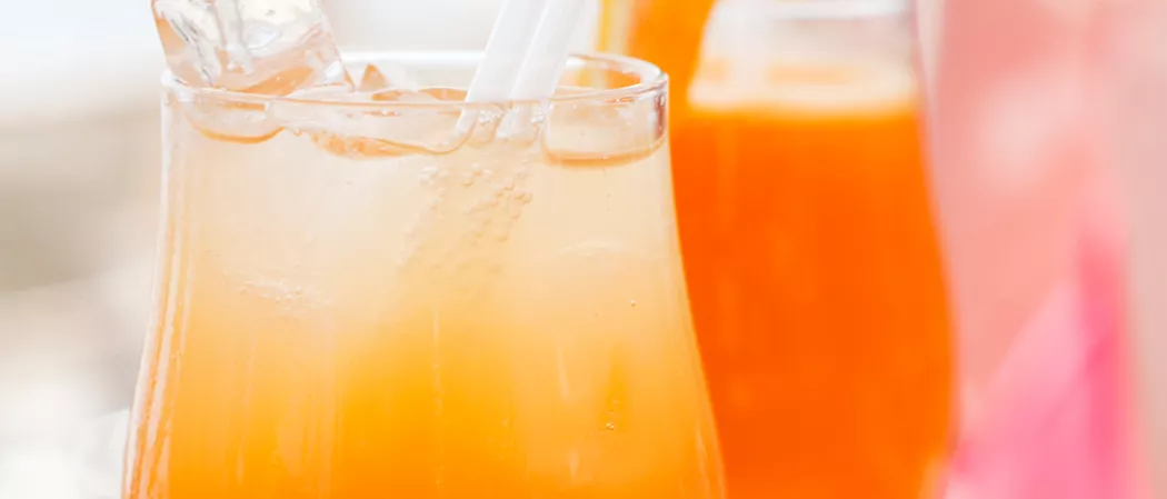Glass of Cruzan® 9 Punch with ice and straws