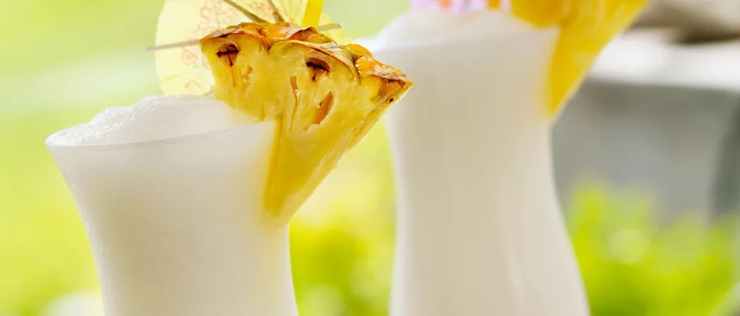 Two glasses of Cruzan® Colada garnished with pineapple slice