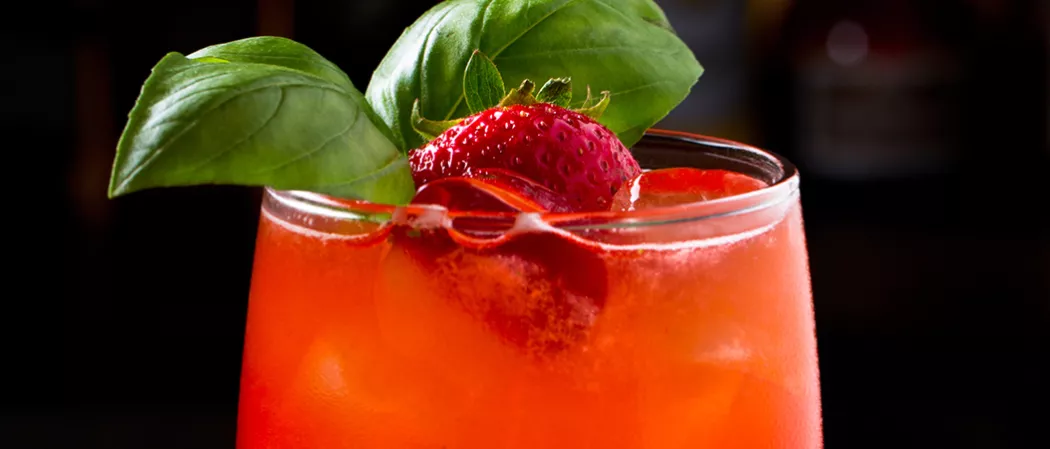 Glass of Berry Burst garnished with mint leaves and strawsberry