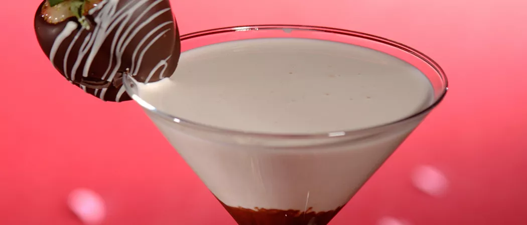 Glass with chocolate at the bottom and Irish Cream above, garnished with a chocolate ball.