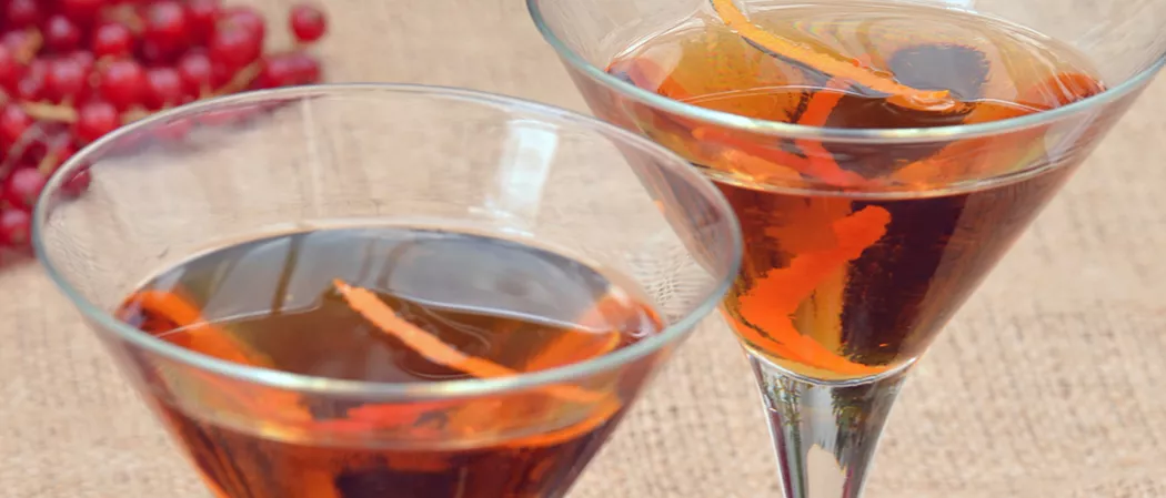 Two glasses of Samuels with orange zest in them.