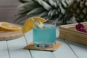 Thumbnail of a video explaining ""How to Make a Blue Hawaii"" in bartending 101
